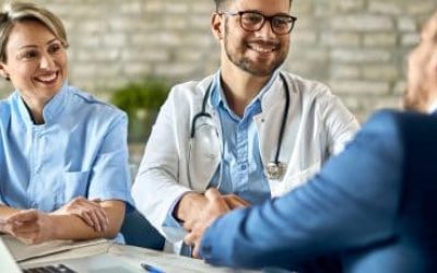 group-healthcare-workers-greeting-financial-advisor-meeting-office-focus-is-young-doctor-scaled-rkxka7g4iys32w5n93mljpkbry4ugif3ae38s3r0n0