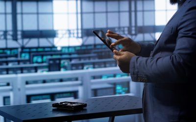 Technician in server hub workplace installing newly ordered storage unit, checking parameters with tablet. IT expert in data center holding device, replacing storage mainframes components, camera A