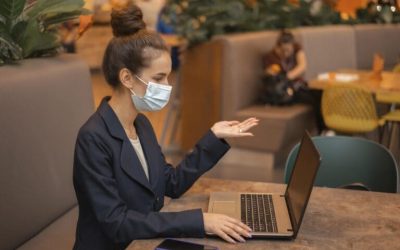 side-view-businesswoman-with-medical-mask-working-her-laptop-1-768x511